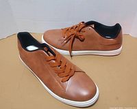 Side view of both shoes showing uppers and laces