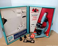 Microscope, accessories and interior of case displayed