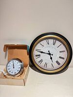 Front view of both clocks displaying faces and relative sizes