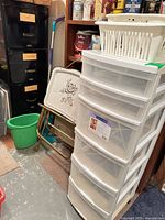 overview showing filing cabinet, drawer tower, trays, bucket, mop, basket