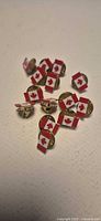 Pile of Canadian flag lapel pins with butterfly clutch backs