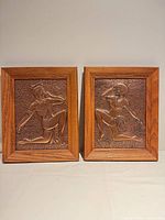 Front view showing both copper relief plaques in wood frames