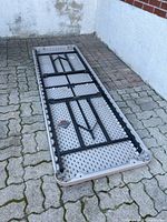 Table folded upside down showing frame and legs