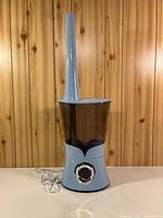 Front view of Air Innovations tower humidifier showing digital control dial and water tank