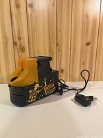 Left front view showing skeleton graphic, yellow chute, power cord