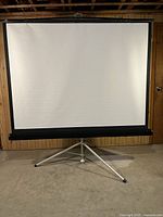 Front view showing white projection surface and tripod base