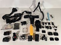 All accessories laid out including harnesses, mounts, housing, remotes, tripod, floating grip