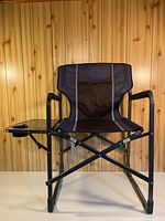 Full view of folding chair showing frame and tray