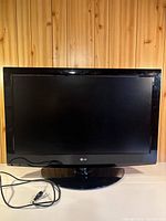 Front view of LG 37-inch flat screen TV on pedestal stand