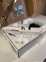 Open box showing foam insert with airplane components and transmitter