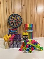 Overview of entire lot with dartboard, bubbles, spray string, bubble wands and water balloons