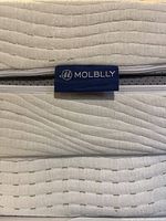 Molblly fabric logo tag and zipper on mattress cover