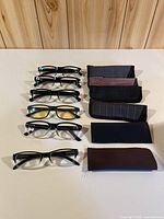 All six pairs of glasses with six cases displayed on table