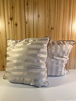 Front view showing stripe side of both pillows