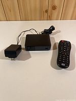 Media player, power adapter and remote laid out