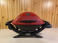 Front view of red Weber Q 1200 grill