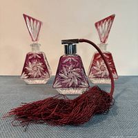 Front view showing two perfume bottles and atomizer