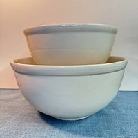 Two nested ironstone mixing bowls showing exterior profile