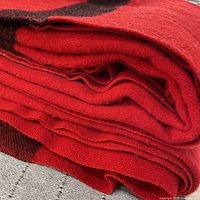 Folded red wool blanket showing color and texture