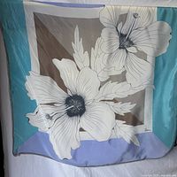 Full view of square silk scarf showing floral print and border colors