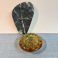 Both ashtrays side by side for scale and comparison