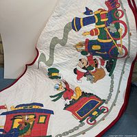 Full view of printed Mickey & Friends Christmas train on quilted tree skirt