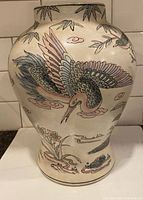Front view of porcelain vase showing crane, bamboo and floral painting
