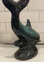 Full view of whale figurine showing tail and base