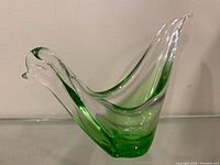 Side profile showing clear to green gradient and bird form