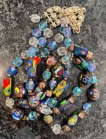 Necklace coiled showing multicolour lampwork beads and clasp pieces