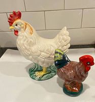 Front view of both ceramic bird figurines