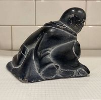 Left side view of soapstone Inuit figure
