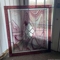 Full view of stained glass panel leaning against door