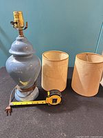 Lamp, two drum shades, tape measure showing height, cord and plug visible