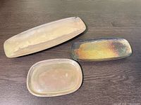 Top view of three tarnished silver-plated trays