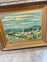 Front view showing entire framed artwork with landscape scene and ornate gold frame