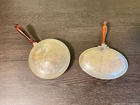 Top view of both hinged serving pans showing lids and handles