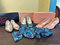 All three pairs of pumps with boxes and accessories visible