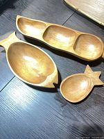All three carved wooden bowls/trays top view