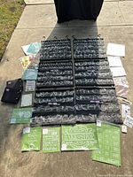 Full lot showing six hanging panels surrounded by assorted stencil sheets, papers, binders and sealed craft packs