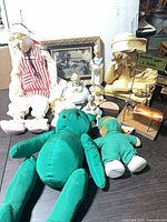 Group shot of all dolls, plush bears, figurines, sculpture, sign and framed print