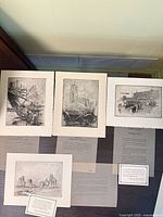 All four prints laid out showing images and accompanying text sheets