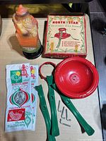 Complete lot laid out with Santa light, tree stand components, original box, and icicle packs