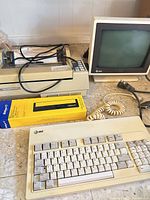 Keyboard, monitor, printer, boxed ribbon shown together