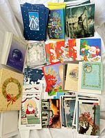 Spread of assorted holiday cards showing multiple designs and envelopes