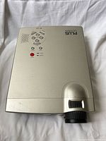 Top view showing branding, control buttons, speaker grille