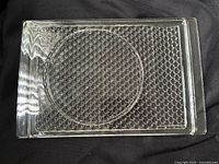 Top view of entire clear glass tray showing bubble pattern and circular recess