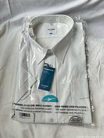 Front view of sealed OLYMP pilot shirt in packaging