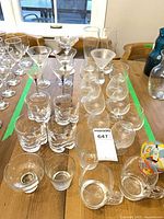 overview of assorted clear glass drinkware on table