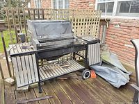 Front view of Weber Platinum Series natural gas barbecue with cover on side